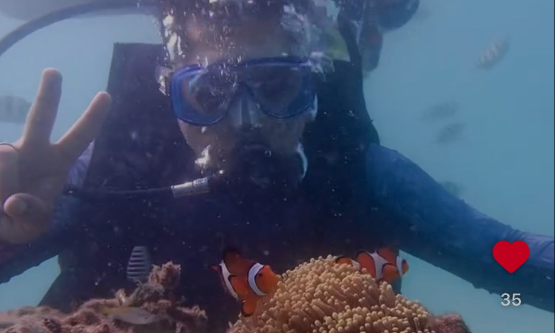 Scuba diving beside a clownfish and anemone