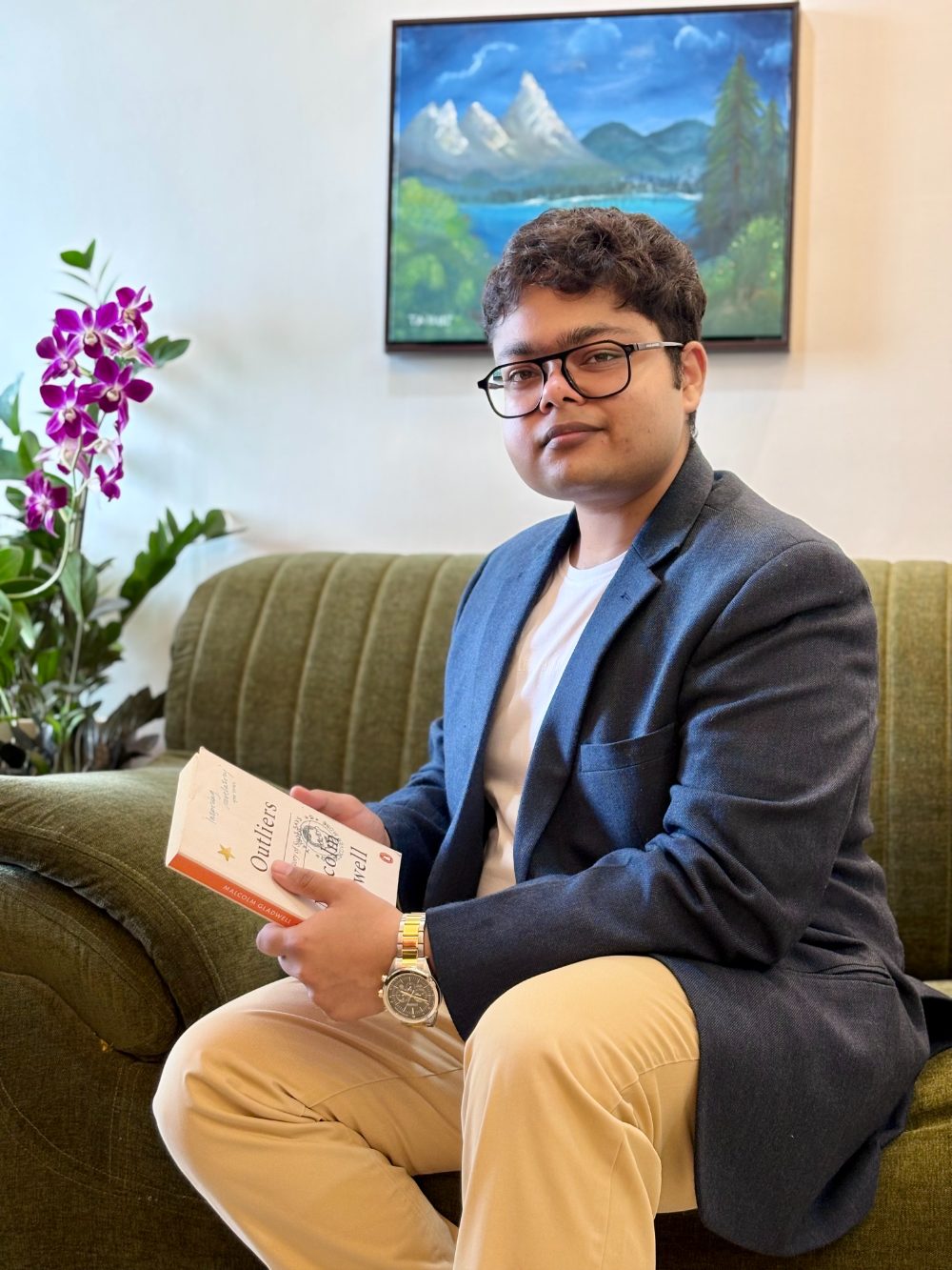 Tanuj Suthar, seated, in a blue blazer